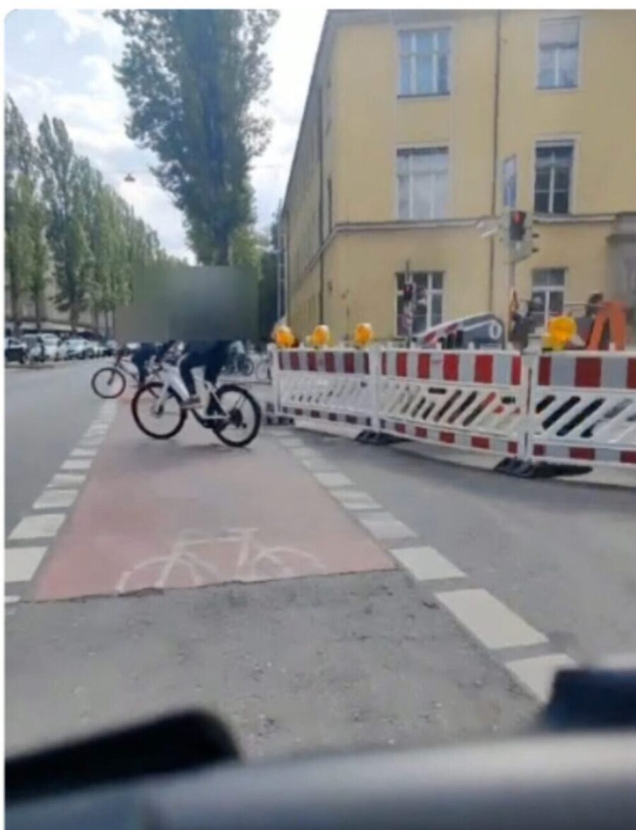 Rider's view: barriers across the cycle route with cyclists diverting around the closed section.